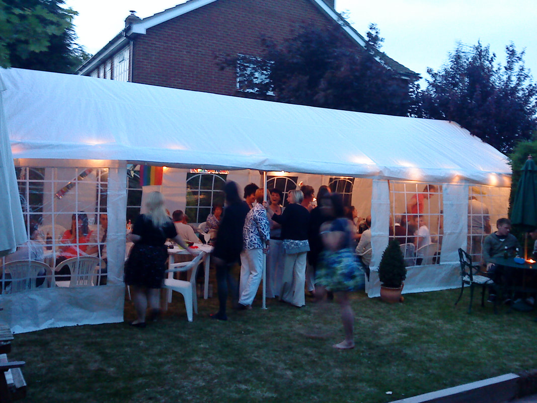 Lit up marquee at garden party Picture